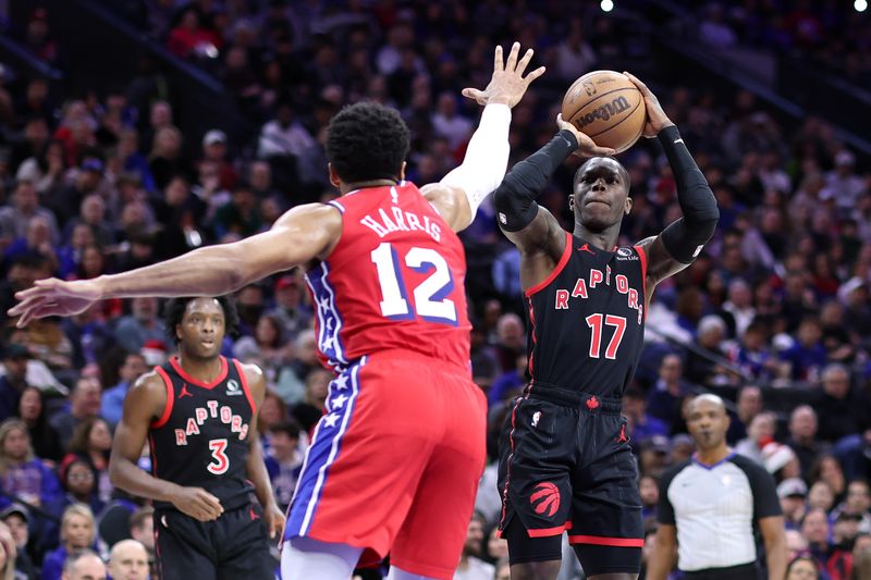 PHILADELPHIA, PENNSYLVANIA - DECEMBER 22: Dennis Schroder #17 of the Toronto Raptors shoots past Tobias Harris #12 of the Philadelphia 76ers during the second quarter at the Wells Fargo Center on December 22, 2023 in Philadelphia, Pennsylvania. NOTE TO USER: User expressly acknowledges and agrees that, by downloading and or using this photograph, User is consenting to the terms and conditions of the Getty Images License Agreement. (Photo by Tim Nwachukwu/Getty Images)