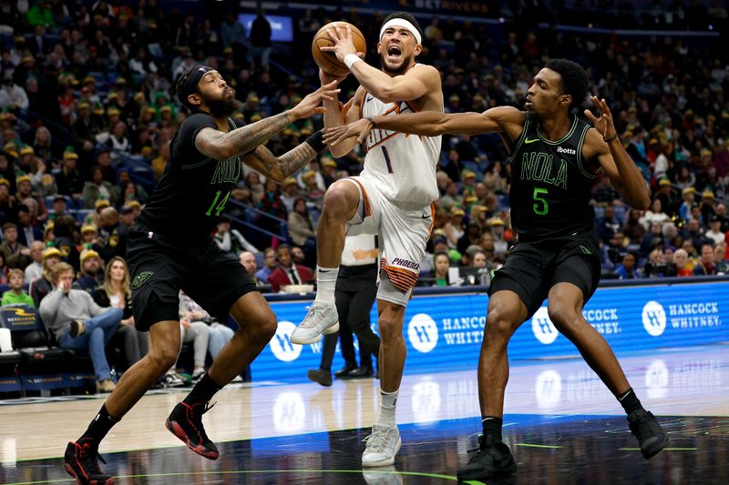 NEW ORLEANS, LOUISIANA - JANUARY 19: Devin Booker #1 of the Phoenix Suns shoots over Brandon Ingram #14 of the New Orleans Pelicans and Herbert Jones #5 of the New Orleans Pelicansduring the third quarter of an NBA game at Smoothie King Center on January 19, 2024 in New Orleans, Louisiana. NOTE TO USER: User expressly acknowledges and agrees that, by downloading and or using this photograph, User is consenting to the terms and conditions of the Getty Images License Agreement. (Photo by Sean Gardner/Getty Images)