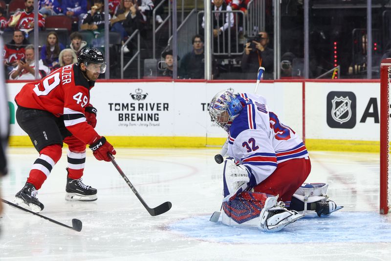 Sep 30, 2024; Newark, New Jersey, USA; New York Rangers goaltender Jonathan Quick (32) makes a save on New Jersey Devils center Ryan Schmelzer (49) during the second period at Prudential Center. Mandatory Credit: Ed Mulholland-Imagn Images