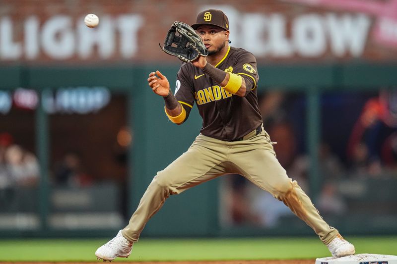 May 20, 2024; Cumberland, Georgia, USA; San Diego Padres second baseman Luis Arraez (4) makes a force out play against the Atlanta Braves during the eighth inning at Truist Park.Mandatory Credit: Dale Zanine-USA TODAY Sports