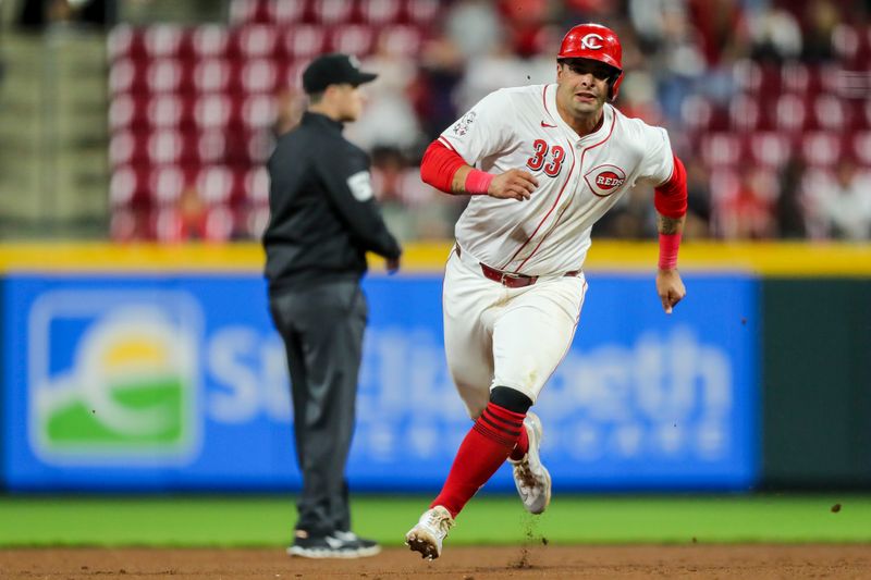 Apr 9, 2024; Cincinnati, Ohio, USA; Cincinnati Reds first baseman Christian Encarnacion-Strand (33) runs to third base on a double hit by outfielder Jake Fraley (not pictured) in the eighth inning against the Milwaukee Brewers at Great American Ball Park. Mandatory Credit: Katie Stratman-USA TODAY Sports