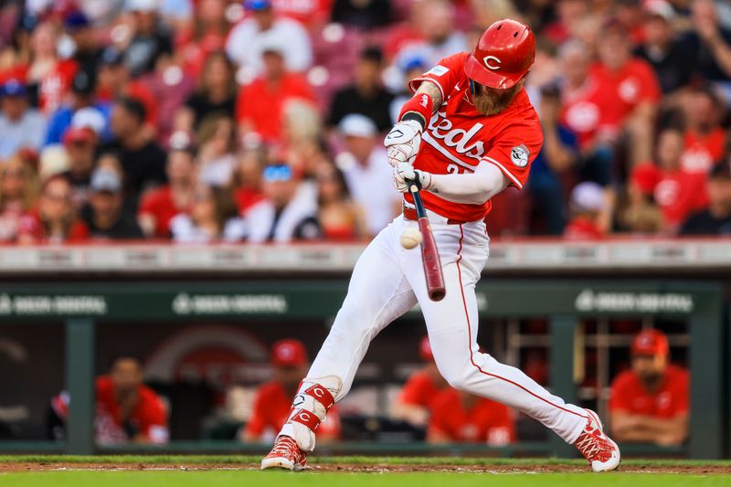 May 25, 2024; Cincinnati, Ohio, USA; Cincinnati Reds outfielder Jake Fraley (27) hits a single against the Los Angeles Dodgers in the first inning at Great American Ball Park. Mandatory Credit: Katie Stratman-USA TODAY Sports