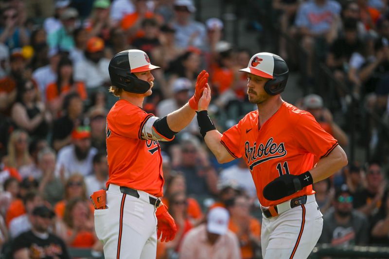 Jun 1, 2024; Baltimore, Maryland, USA;  Baltimore Orioles third baseman Jordan Westburg (11) high fives Baltimore Orioles shortstop Gunnar Henderson (2) after scoring during the third inning at Oriole Park at Camden Yards. Mandatory Credit: Tommy Gilligan-USA TODAY Sports