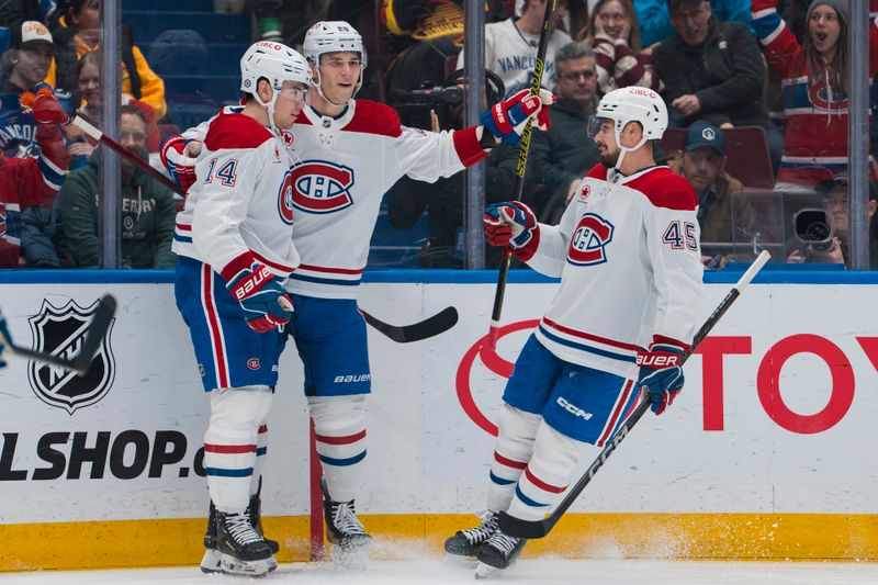 Mar 11, 2025; Vancouver, British Columbia, CAN; Montreal Canadiens forward Nick Suzuki (14) and forward Juraj Slafkovsky (20) and defenseman Alexandre Carrier (45) celebrate Suzuki’s goal against the Vancouver Canucks in the first period at Rogers Arena. Mandatory Credit: Bob Frid-Imagn Images