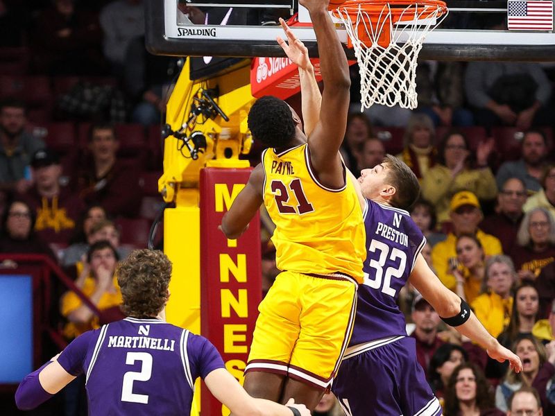 Feb 3, 2024; Minneapolis, Minnesota, USA; Minnesota Golden Gophers forward Pharrel Payne (21) dunks as Northwestern Wildcats forward Blake Preston (32) defends during the second half at Williams Arena. Mandatory Credit: Matt Krohn-USA TODAY Sports