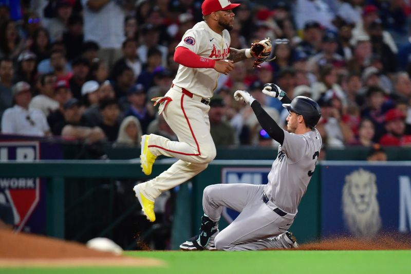 May 27, 2025; Anaheim, California, USA; New York Yankees left fielder Cody Bellinger (35) reaches third on an error committed by Los Angeles Angels center fielder Matthew Lugo (15) during the sixth inning at Angel Stadium. Mandatory Credit: Gary A. Vasquez-Imagn Images