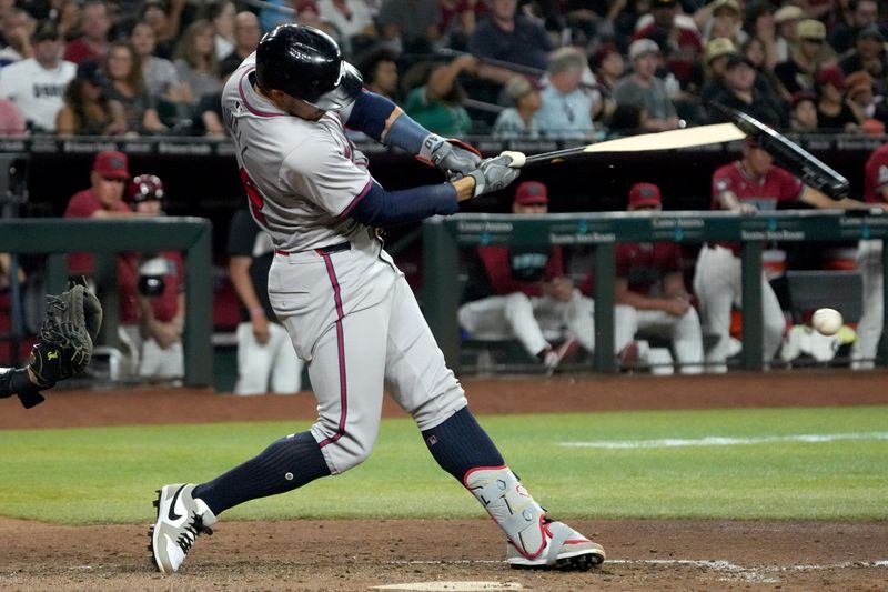 Jul 11, 2024; Phoenix, Arizona, USA; Atlanta Braves outfielder Adam Duvall (14) breaks his bat against the Arizona Diamondbacks in the seventh inning at Chase Field. Mandatory Credit: Rick Scuteri-USA TODAY Sports