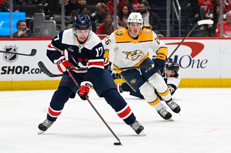 Dec 30, 2023; Washington, District of Columbia, USA; Washington Capitals center Dylan Strome (17) handles the puck as Nashville Predators center Philip Tomasino (26) chases during the second period at Capital One Arena. Mandatory Credit: Brad Mills-USA TODAY Sports