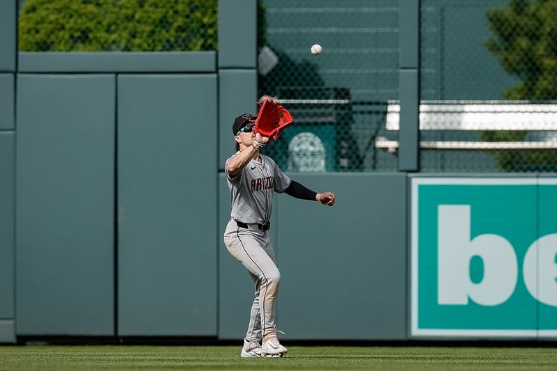 Apr 10, 2024; Denver, Colorado, USA; Arizona Diamondbacks center fielder Corbin Carroll (7) makes a catch for the final out of the game against the Colorado Rockies at Coors Field. Mandatory Credit: Isaiah J. Downing-USA TODAY Sports