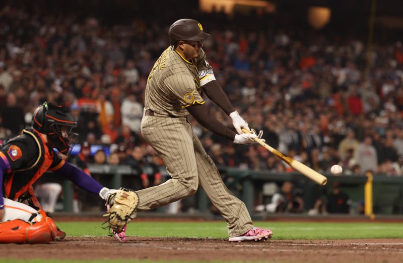 Jun 3, 2025; San Francisco, California, USA; San Diego Padres third baseman Manny Machado (13) hits a two run single against the San Francisco Giants during the ninth inning at Oracle Park. Mandatory Credit: Kelley L Cox-Imagn Images