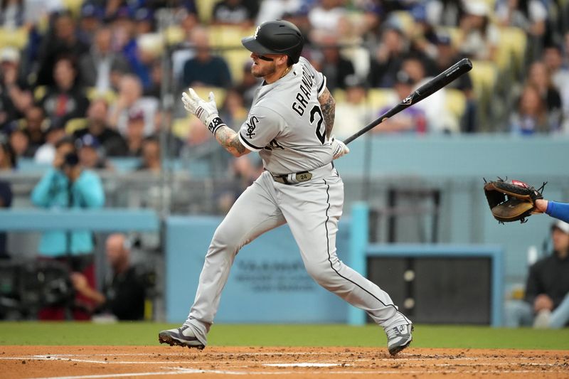 Jun 15, 2023; Los Angeles, California, USA; Chicago White Sox catcher Yasmani Grandal (24) follows through on a single in the second inning against the Los Angeles Dodgers at Dodger Stadium. Mandatory Credit: Kirby Lee-USA TODAY Sports