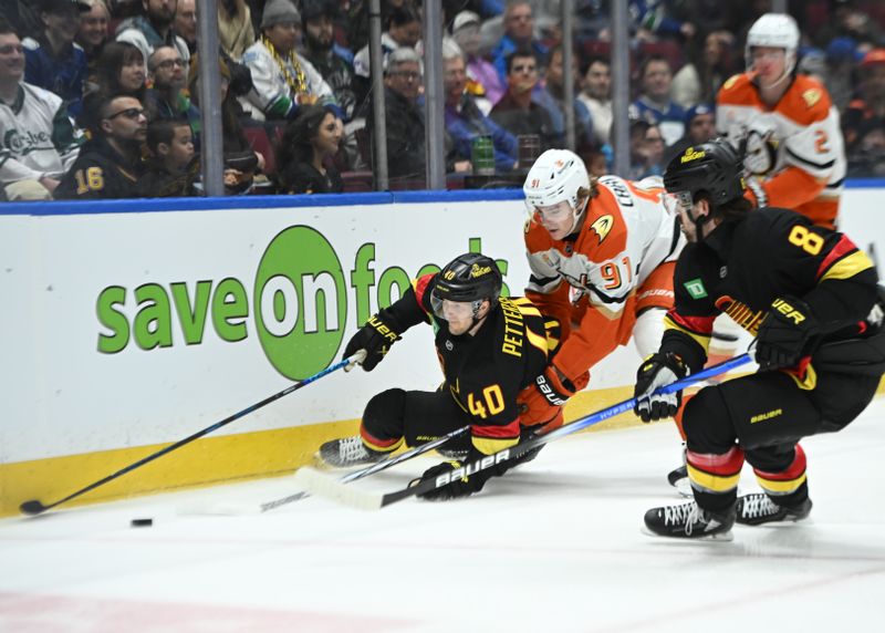 Mar 5, 2025; Vancouver, British Columbia, CAN; Anaheim Ducks forward Leo Carlsson (91) checks Vancouver Canucks forward Elias Pettersson (40)  at Rogers Arena during the first period. Mandatory Credit: Simon Fearn-Imagn Images