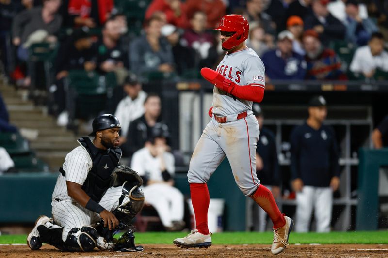 Sep 24, 2024; Chicago, Illinois, USA; Los Angeles Angels outfielder Kevin Pillar (12) scores against the Chicago White Sox during the seventh inning at Guaranteed Rate Field. Mandatory Credit: Kamil Krzaczynski-Imagn Images