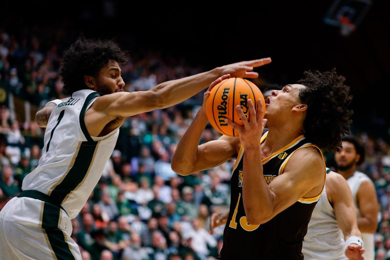 Feb 14, 2026; Fort Collins, Colorado, USA; Colorado State Rams guard Josh Pascarelli (1) swats the ball away from Wyoming Cowboys guard Adam Harakow (13) in the first half at Moby Arena. Mandatory Credit: Isaiah J. Downing-Imagn Images