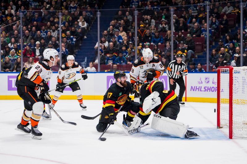 Nov 28, 2023; Vancouver, British Columbia, CAN; Vancouver Canucks defenseman Filip Hronek (17) and Anaheim Ducks forward Jakob Silfverberg (33) and forward Mason McTavish (23) watch the puck hit the goal post behind goalie Thatcher Demko (35)  in the third period at Rogers Arena. Vancouver won 3-1. Mandatory Credit: Bob Frid-USA TODAY Sports