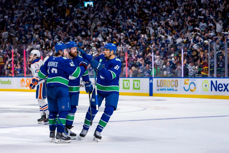 May 20, 2024; Vancouver, British Columbia, CAN; Vancouver Canucks defenseman Quinn Hughes (43) and defenseman Filip Hronek (17) and forward Dakota Joshua (81) celebrate Hronek’s goal against the Edmonton Oilers during the third period in game seven of the second round of the 2024 Stanley Cup Playoffs at Rogers Arena. Mandatory Credit: Bob Frid-USA TODAY Sports