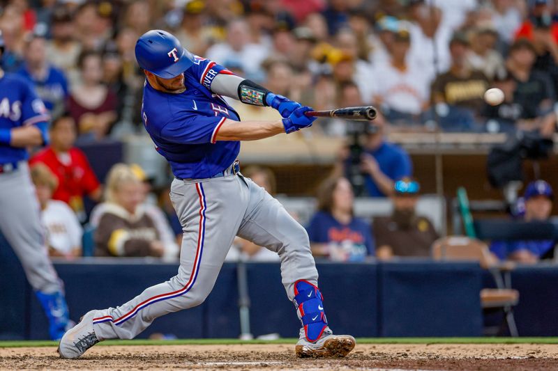 Jul 29, 2023; San Diego, California, USA; Texas Rangers catcher Mitch Garver (18) hits a double in the seventh inning against the San Diego Padres at Petco Park. Mandatory Credit: David Frerker-USA TODAY Sports