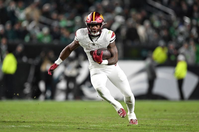 Washington Commanders running back Brian Robinson Jr. runs the ball during the first half of an NFL football game against the Philadelphia Eagles, Thursday, Nov. 14, 2024, in, Philadelphia. (AP Photo/Terrance Williams)