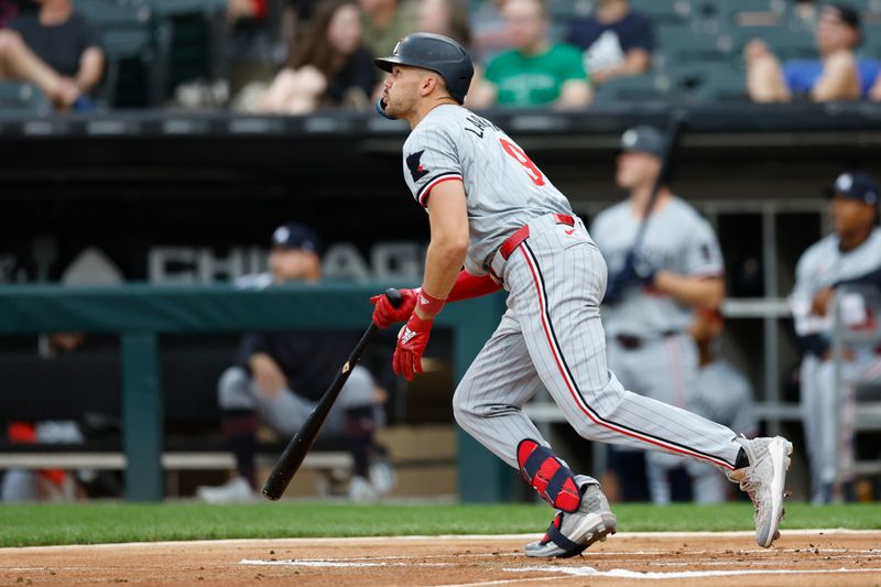 Jul 8, 2024; Chicago, Illinois, USA; Minnesota Twins outfielder Trevor Larnach (9) watches his solo home run against the Chicago White Sox during the first inning at Guaranteed Rate Field. Mandatory Credit: Kamil Krzaczynski-USA TODAY Sports