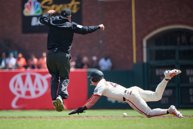 Apr 10, 2024; San Francisco, California, USA; San Francisco Giants shortstop Tyler Fitzgerald (49) slides into second base and umpire Dan Bellino (2) leaps to avoid the throw during the second inning at Oracle Park. Mandatory Credit: Robert Edwards-USA TODAY Sports