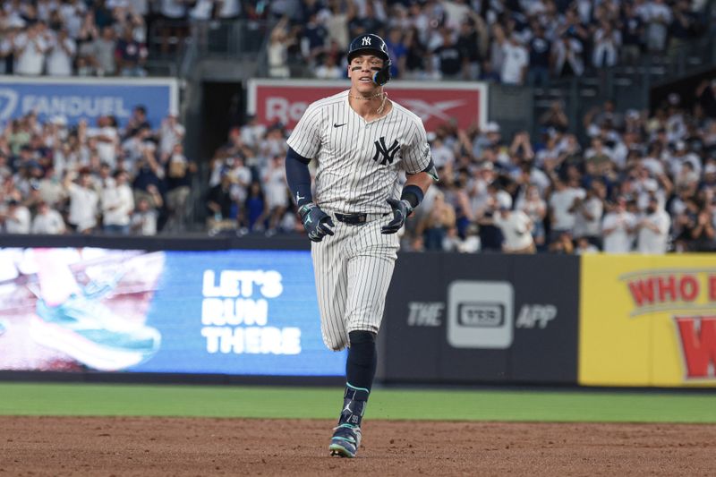 Jun 8, 2024; Bronx, New York, USA; New York Yankees center fielder Aaron Judge (99) runs the bases after his solo home run during the third inning against the Los Angeles Dodgers at Yankee Stadium. Mandatory Credit: Vincent Carchietta-USA TODAY Sports