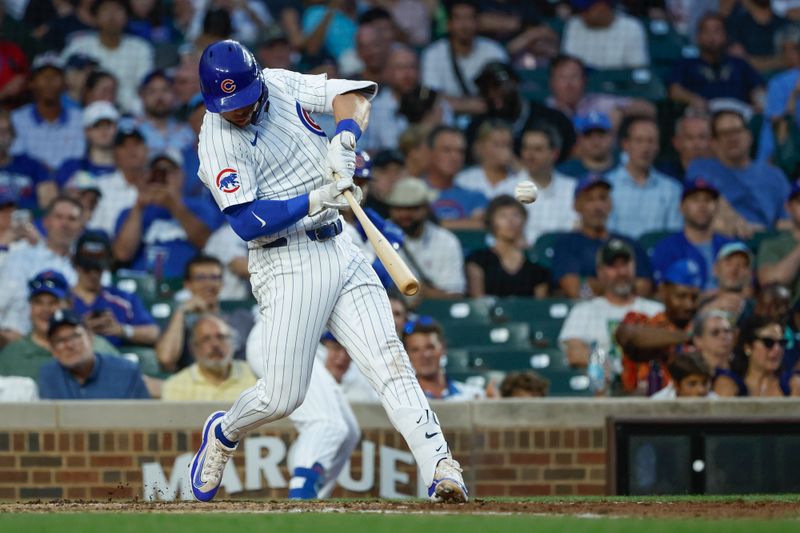 Jun 17, 2024; Chicago, Illinois, USA; Chicago Cubs second baseman Nico Hoerner (2) singles against the San Francisco Giants during the fourth inning at Wrigley Field. Mandatory Credit: Kamil Krzaczynski-USA TODAY Sports