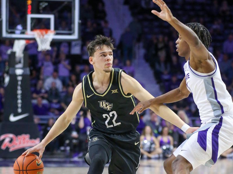 Jan 6, 2024; Manhattan, Kansas, USA; UCF Knights forward Nils Machowski (22) dribbles against Kansas State Wildcats guard Dai Dai Ames (4) during the second half at Bramlage Coliseum. Mandatory Credit: Scott Sewell-USA TODAY Sports