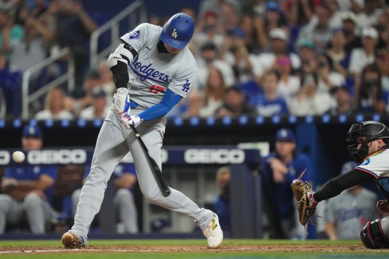 Sep 17, 2024; Miami, Florida, USA;  Los Angeles Dodgers designated hitter Shohei Ohtani (17) hits a two-run home run in the third inning against the Miami Marlins at loanDepot Park. Mandatory Credit: Jim Rassol-Imagn Images