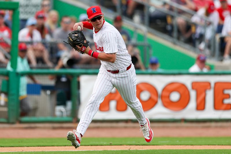 Mar 5, 2024; Clearwater, Florida, USA;  Philadelphia Phillies third baseman Nick Podkul (80) looks to throw to first base against the Baltimore Orioles in the sixth inning at BayCare Ballpark. Mandatory Credit: Nathan Ray Seebeck-USA TODAY Sports