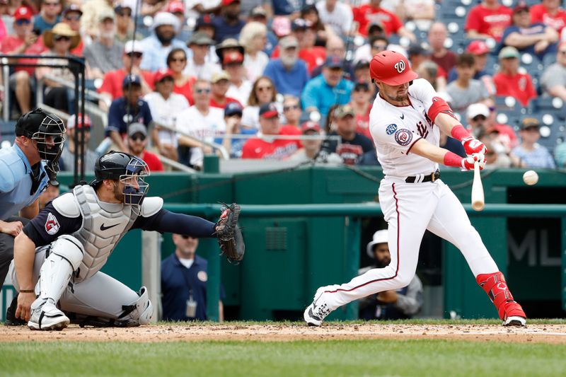 Apr 16, 2023; Washington, District of Columbia, USA; Washington Nationals right fielder Lane Thomas (28) hits an RBI double against the Cleveland Guardians during the second inning at Nationals Park. Mandatory Credit: Geoff Burke-USA TODAY Sports