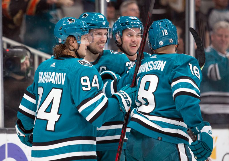 Mar 14, 2023; San Jose, California, USA; San Jose Sharks center Logan Couture (second from left) is congratulated by his teammates on his goal against the Columbus Blue Jackets during the second period at SAP Center at San Jose. Mandatory Credit: D. Ross Cameron-USA TODAY Sports