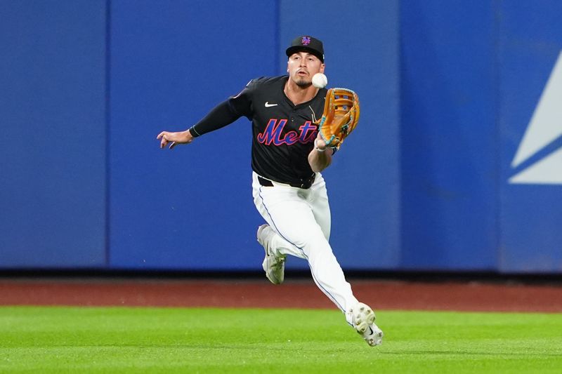 Jun 14, 2024; New York City, New York, USA;  New York Mets center fielder Tyrone Taylor (15) catches a line drive hit by San Diego Padres right fielder Frenando Tatis Jr. (not pictured) during the first inning at Citi Field. Mandatory Credit: Gregory Fisher-USA TODAY Sports