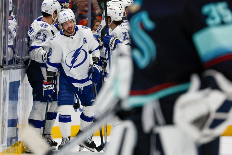 Dec 9, 2023; Seattle, Washington, USA; Tampa Bay Lightning right wing Nikita Kucherov (86, second from left), celebrates with teammates after scoring a goal against the Seattle Kraken during overtime at Climate Pledge Arena. Mandatory Credit: Joe Nicholson-USA TODAY Sports