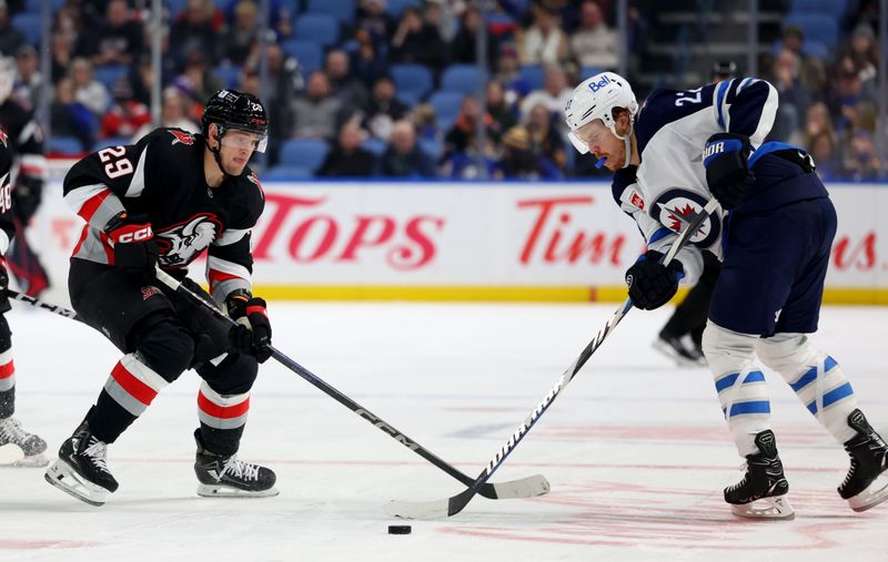 Dec 5, 2024; Buffalo, New York, USA;  Buffalo Sabres left wing Beck Malenstyn (29) and Winnipeg Jets center Mason Appleton (22) go after a loose puck during the second period at KeyBank Center. Mandatory Credit: Timothy T. Ludwig-Imagn Images