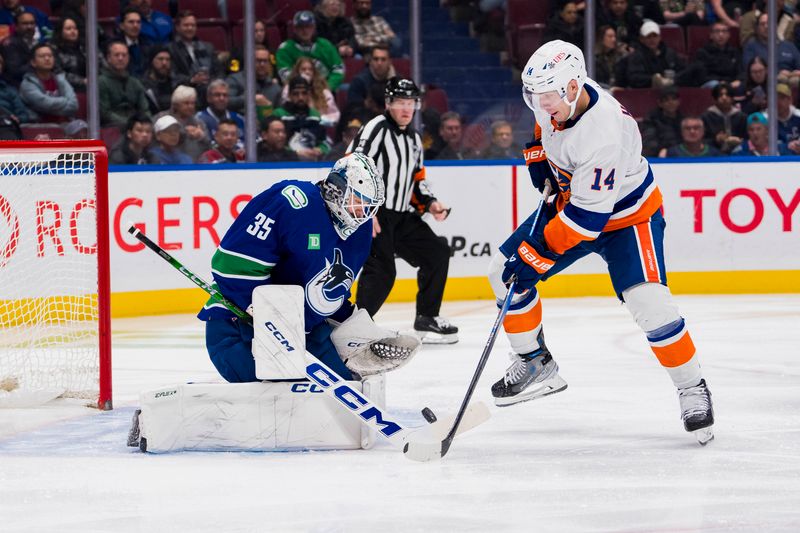 Nov 15, 2023; Vancouver, British Columbia, CAN; Vancouver Canucks goalie Thatcher Demko (35) makes a save on New York Islanders forward Bo Horvat (14) in the second period at Rogers Arena. Mandatory Credit: Bob Frid-USA TODAY Sports