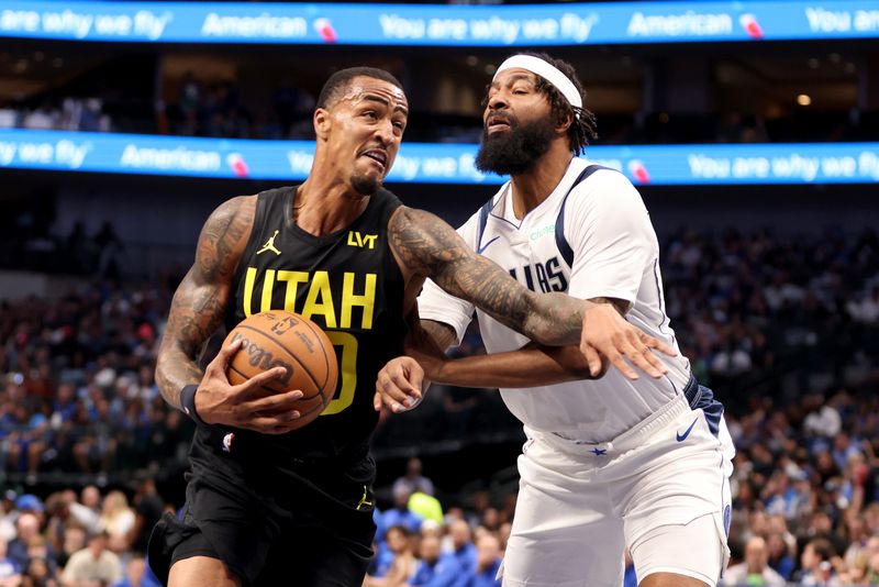 DALLAS, TEXAS - OCTOBER 10: John Collins #20 of the Utah Jazz drives to the basket against Jamarion Sharp #33 of the Dallas Mavericks in the second half at American Airlines Center on October 10, 2024 in Dallas, Texas. NOTE TO USER: User expressly acknowledges and agrees that, by downloading and or using this Photograph, user is consenting to the terms and conditions of the Getty Images License Agreement. Mandatory Copyright Notice: Copyright 2024 NBAE  (Photo by Tim Heitman/Getty Images)