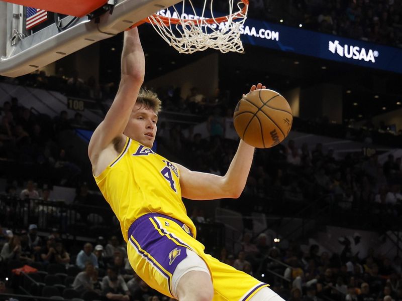 SAN ANTONIO, TEXAS - NOVEMBER 27: Dalton Knecht #4 of the Los Angeles Lakers dunks the ball during the fourth quarter against the San Antonio Spurs at Frost Bank Center on November 27, 2024 in San Antonio, Texas. NOTE TO USER: User expressly acknowledges and agrees that, by downloading and or using this photograph, User is consenting to the terms and conditions of the Getty Images License Agreement (Photo by Ronald Cortes/Getty Images)