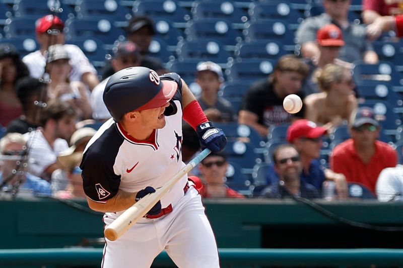 Jun 20, 2024; Washington, District of Columbia, USA; Washington Nationals outfielder Jacob Young (30) attempts a bunt against the Arizona Diamondbacks during the eighth inning at Nationals Park. Mandatory Credit: Geoff Burke-USA TODAY Sports