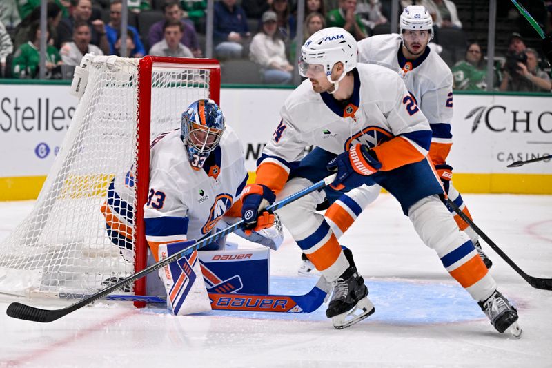 Nov 18, 2025; Dallas, Texas, USA; New York Islanders goaltender David Rittich (33) and defenseman Scott Mayfield (24) faces the Dallas Stars attack during the second period at the American Airlines Center. Mandatory Credit: Jerome Miron-Imagn Images