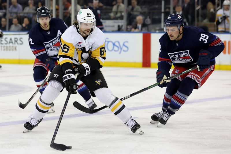 Dec 6, 2024; New York, New York, USA; Pittsburgh Penguins defenseman Erik Karlsson (65) skates with the puck against New York Rangers center Sam Carrick (39) and left wing Artemi Panarin (10) during the second period at Madison Square Garden. Mandatory Credit: Brad Penner-Imagn Images