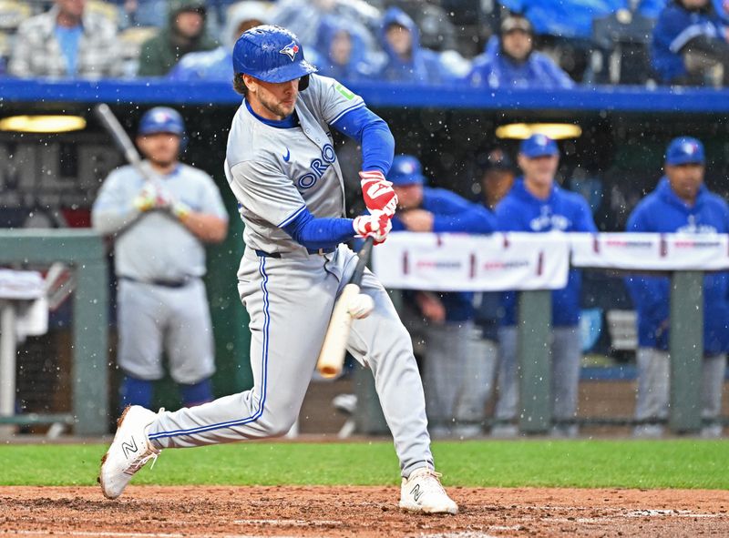 Apr 25, 2024; Kansas City, Missouri, USA;  Toronto Blue Jays third baseman Ernie Clement (28) hits an RBI single in the fourth inning against the Kansas City Royals at Kauffman Stadium. Mandatory Credit: Peter Aiken-USA TODAY Sports