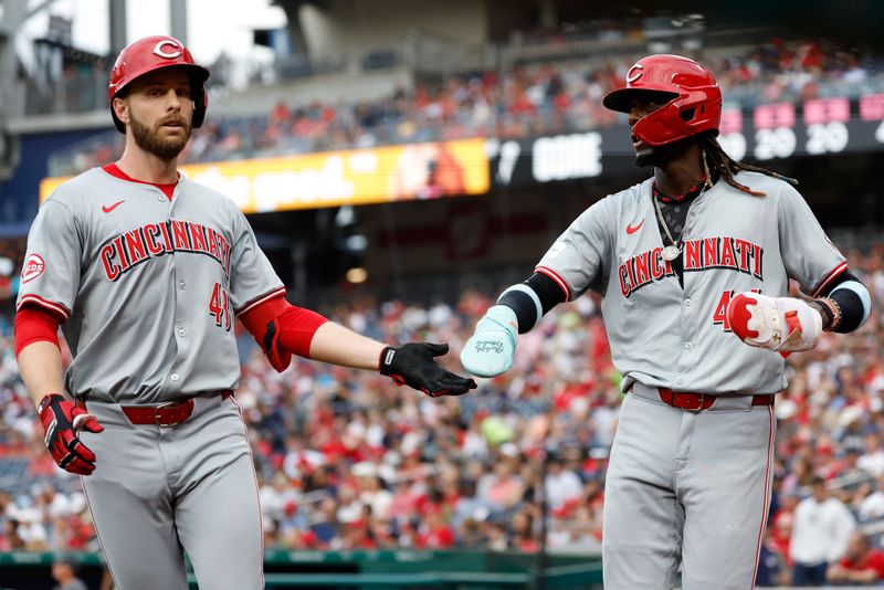 Jul 20, 2024; Washington, District of Columbia, USA; Cincinnati Reds outfielder Austin Slater (48) celebrates with Reds shortstop Elly De La Cruz (44) after hitting a sacrifice fly RBI against the Washington Nationals during the first inning at Nationals Park. Mandatory Credit: Geoff Burke-USA TODAY Sports