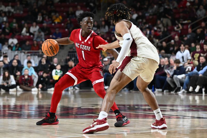 Feb 11, 2023; Chestnut Hill, Massachusetts, USA; North Carolina State Wolfpack guard Jarkel Joiner (1) dribbles the ball against Boston College Eagles forward T.J. Bickerstaff (1) during the second half at the Conte Forum. Mandatory Credit: Brian Fluharty-USA TODAY Sports