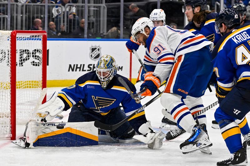 Feb 15, 2024; St. Louis, Missouri, USA;  St. Louis Blues goaltender Jordan Binnington (50) defends the net against Edmonton Oilers left wing Evander Kane (91) during the third period at Enterprise Center. Mandatory Credit: Jeff Curry-USA TODAY Sports