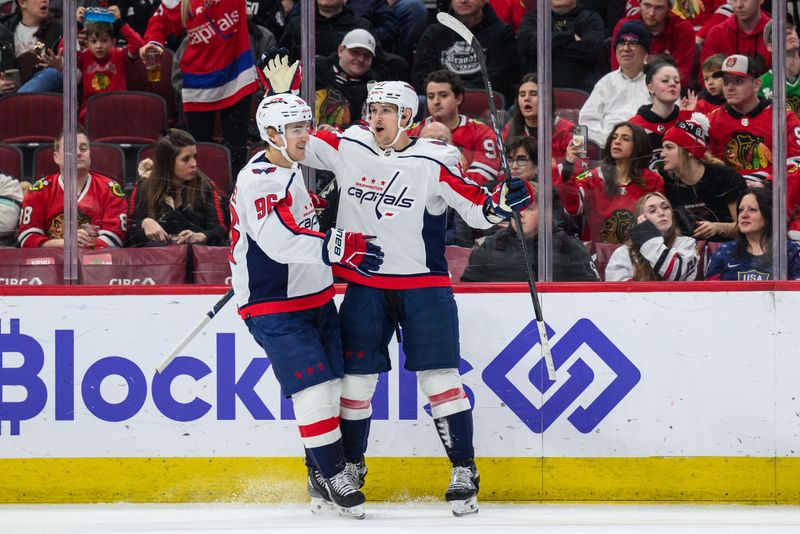 Dec 10, 2023; Chicago, Illinois, USA; Washington Capitals left wing Beck Malenstyn (47) celebrates his goal with right wing Nicolas Aube-Kubel (96) against the Chicago Blackhawks during the second period at the United Center. Mandatory Credit: Daniel Bartel-USA TODAY Sports