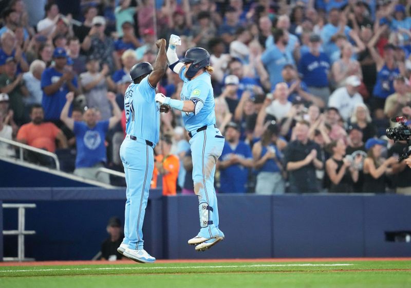 Jul 23, 2024; Toronto, Ontario, CAN; Toronto Blue Jays designated hitter Justin Turner (2) hits home run and celebrates with third base coach Carlos Febles (51) against the Tampa Bay Rays during the sixth inning at Rogers Centre. Mandatory Credit: Nick Turchiaro-USA TODAY Sports