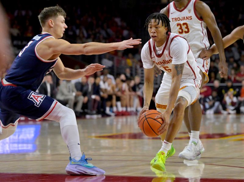 Mar 2, 2023; Los Angeles, California, USA;  USC Trojans guard Boogie Ellis (5) drives past Arizona Wildcats guard Pelle Larsson (3) in the first half at Galen Center. Mandatory Credit: Jayne Kamin-Oncea-USA TODAY Sports