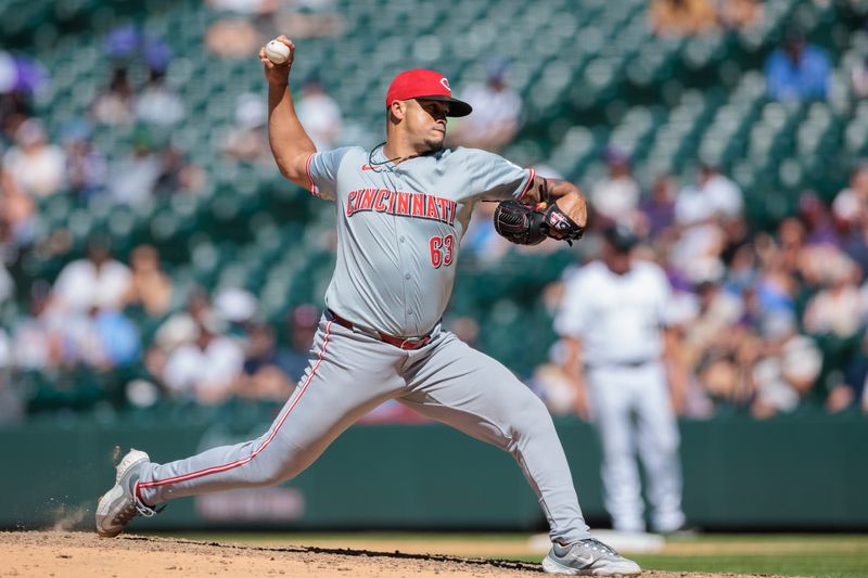 Jun 5, 2024; Denver, Colorado, USA; Cincinnati Reds relief pitcher Fernando Cruz (63) delivers a pitch during the eighth inning against the Colorado Rockies at Coors Field. Mandatory Credit: Andrew Wevers-USA TODAY Sports