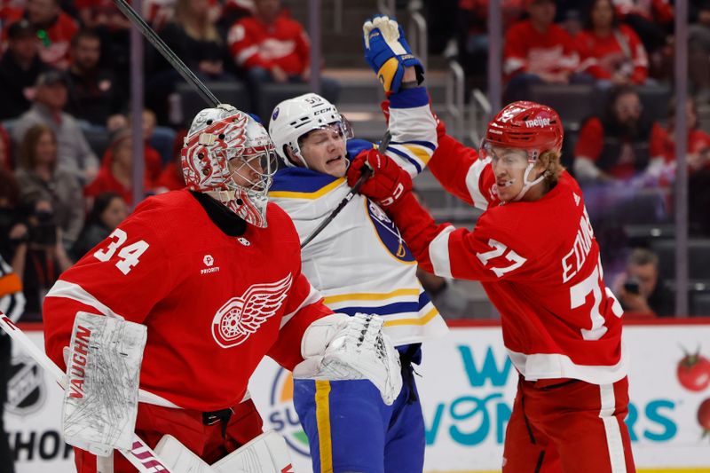 Apr 7, 2024; Detroit, Michigan, USA; Buffalo Sabres left wing Eric Robinson (50) and Detroit Red Wings defenseman Simon Edvinsson (77) fight for position in front of goaltender Alex Lyon (34) in the first period at Little Caesars Arena. Mandatory Credit: Rick Osentoski-USA TODAY Sports