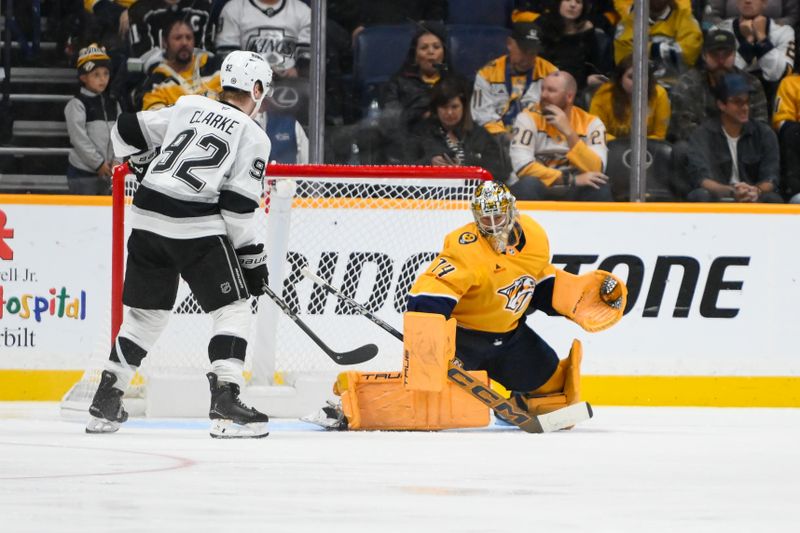 Nov 4, 2024; Nashville, Tennessee, USA;  Nashville Predators goaltender Juuse Saros (74) blocks the shot of of Los Angeles Kings defenseman Brandt Clarke (92) during the third period at Bridgestone Arena. Mandatory Credit: Steve Roberts-Imagn Images